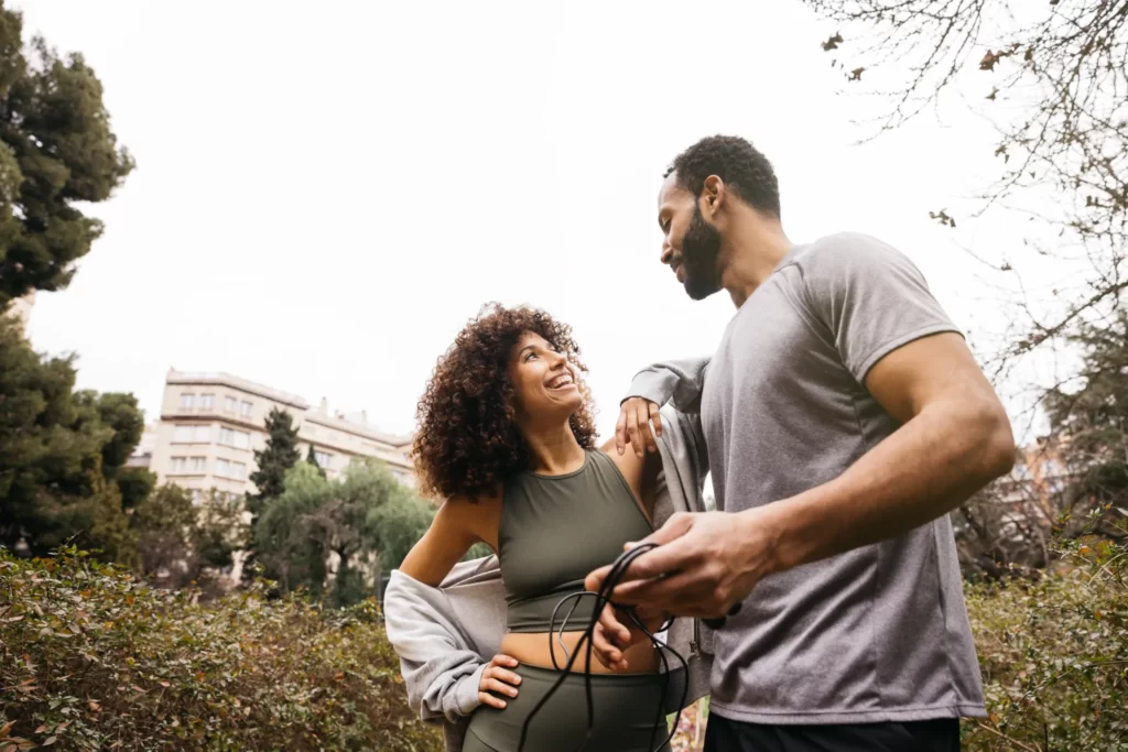 couple resting after exercising in the park utc